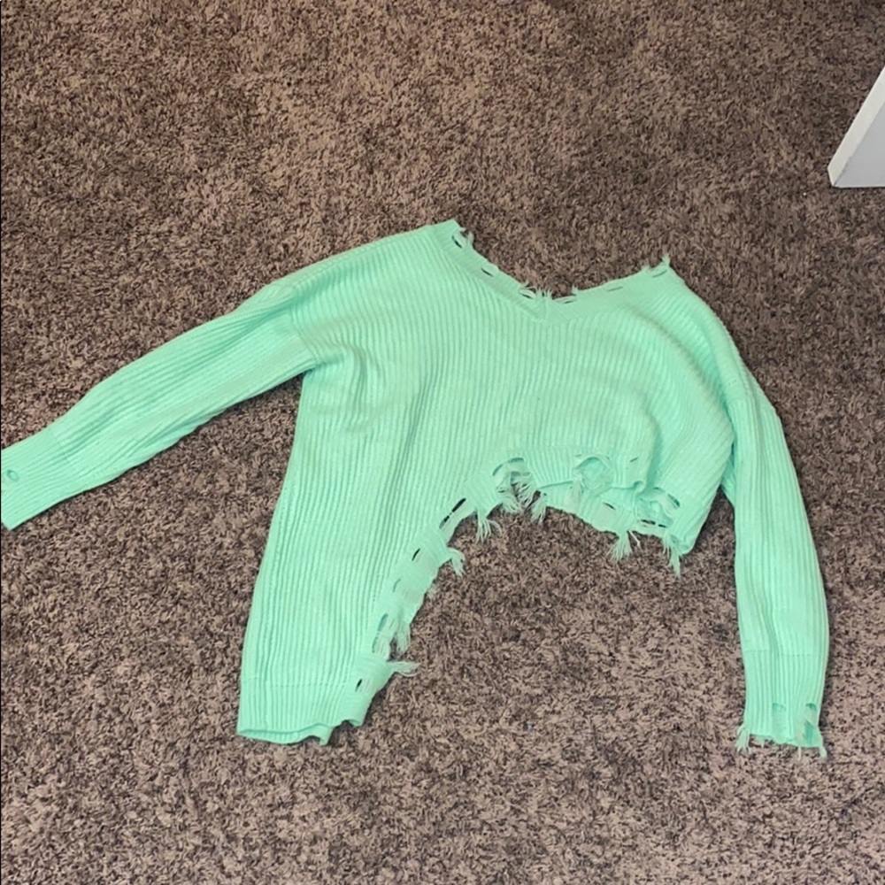 A green ripped sweater